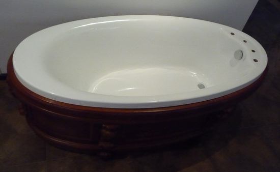 Free standing soaking soft tub with brown antique apron
