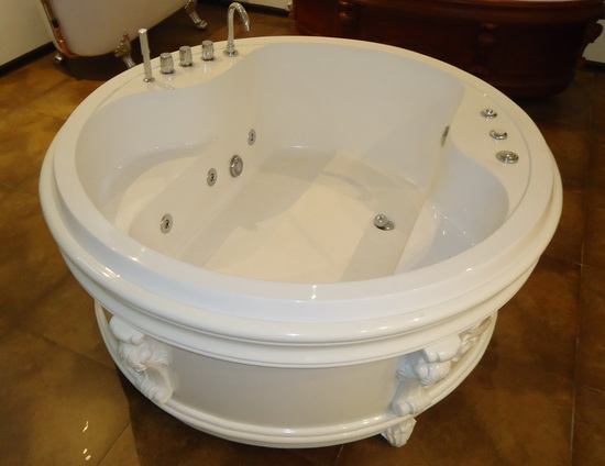 Round freestanding soft tub in showroom